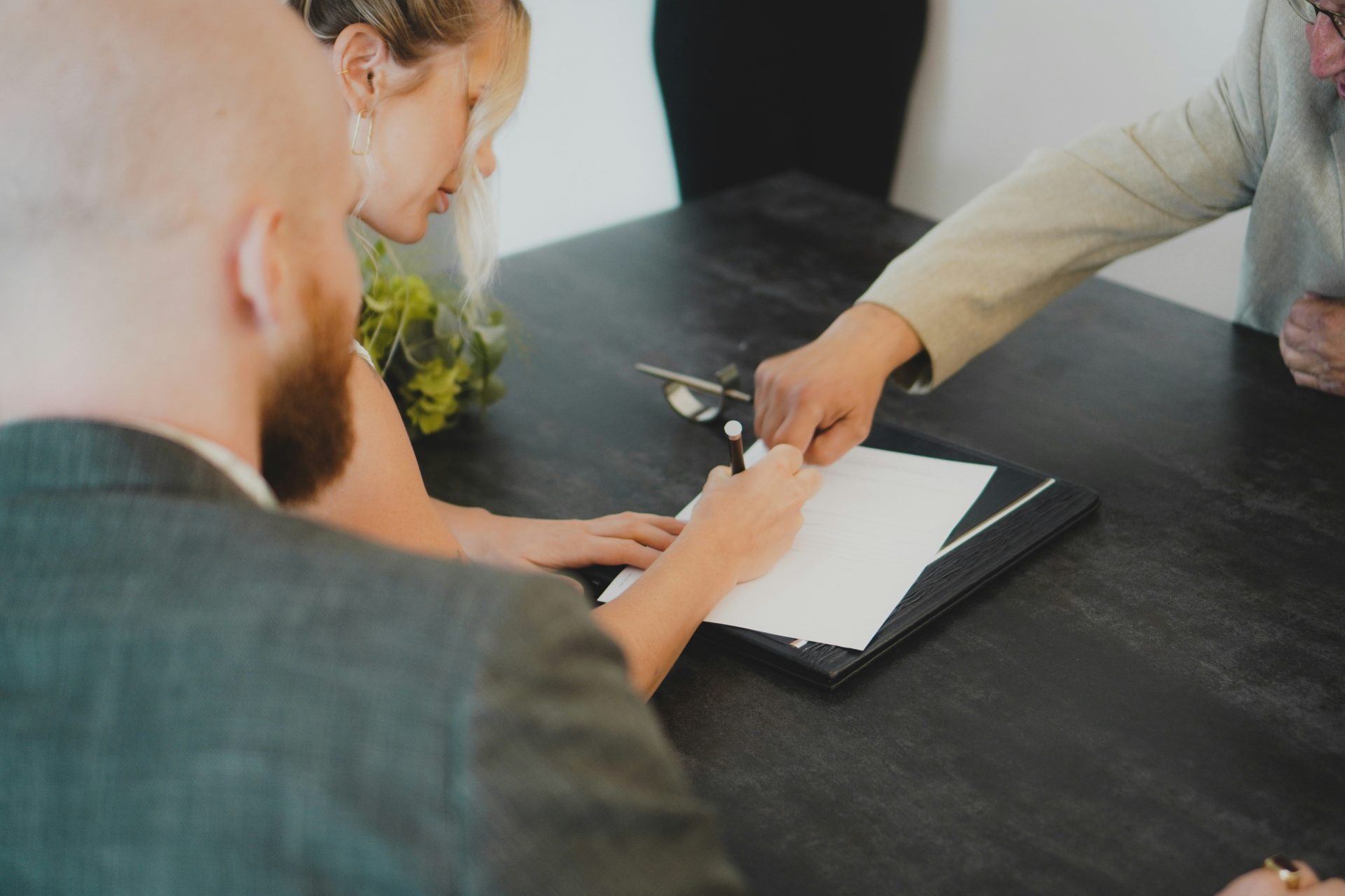 couple signing document at desk